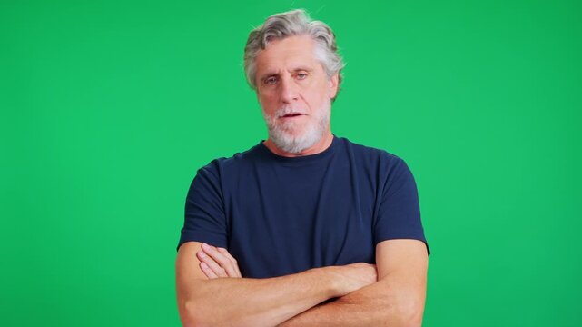 Mature man shaking head no and crossing his arms on green screen