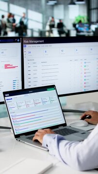Project Manager Reviewing OKR Progress Dashboard On Laptop