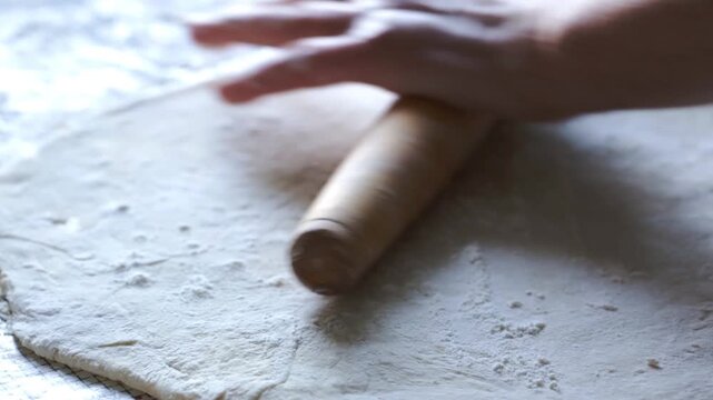 Preparing and rolling out dough for making dumplings at home, making ravioli