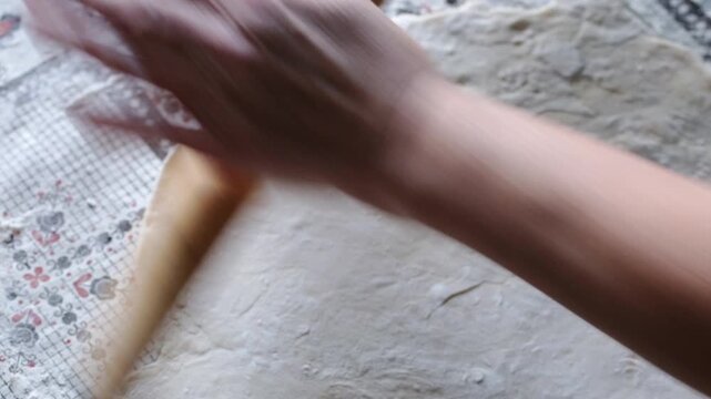 Preparing and rolling out dough for making dumplings at home