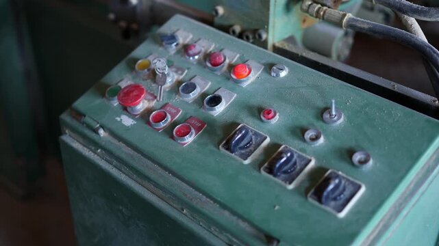 Person in glove pushing button on dusty control panel
