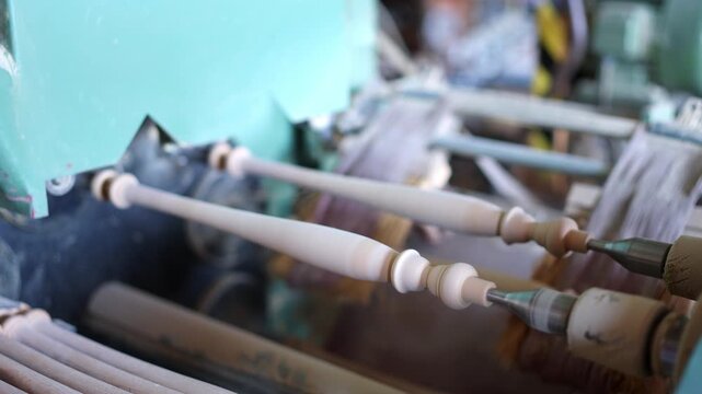 Wooden furniture leg turning on a lathe machine
