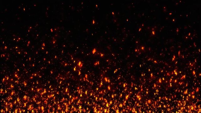 Fire sparks and glowing embers rising against a solid black background. Cinematic particle effect with orange and red light. Abstract heat and energy motion footage.