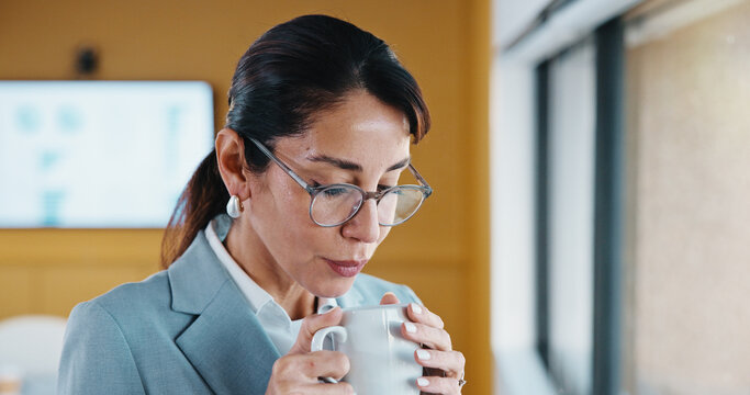 Woman, coffee and scent at window in office with thinking, break or glasses at insurance company. Person, broker and advisor with beverage, tea cup or warm drink with career at risk assessment agency