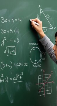 Student hand writing math equations on a green chalkboard. Educational setting for learning and academic pursuits.