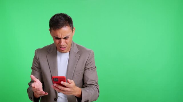 Frustrated angry businessman using a mobile phone