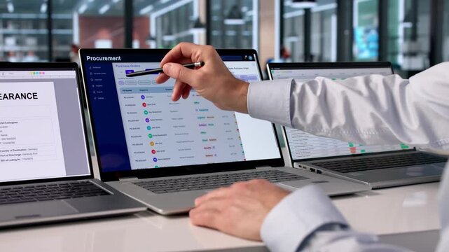 Procurement Manager Reviews Supplier Contracts Using Software