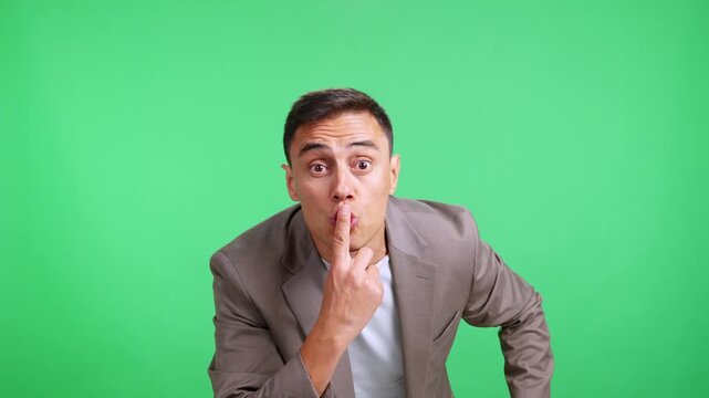 Businessman asking for silence with finger on lips