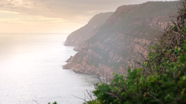 Impressive coastal cliffs and geology of Robberg Nature Reserve peninsula at sunrise in Plettenberg Bay