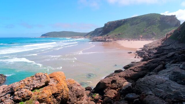 Pristine beach with blue ocean waves crashing on shore at Robberg Nature Reserve