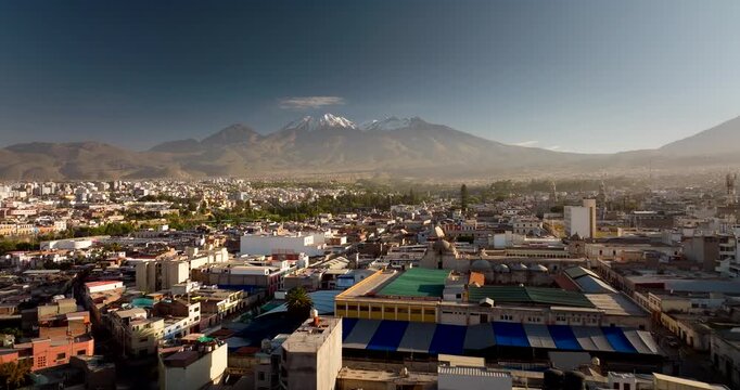 Arequipa, the white city, with snow capped peaks of El Misti and Chachani volcanoes in Peru. Aerial forward, copy space