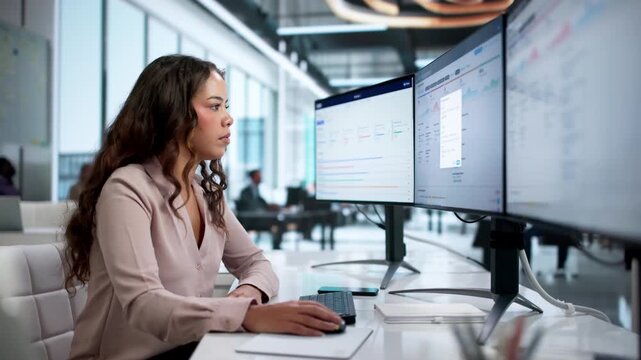 Quality Manager Reviews Compliance Reports On Desktop Computer