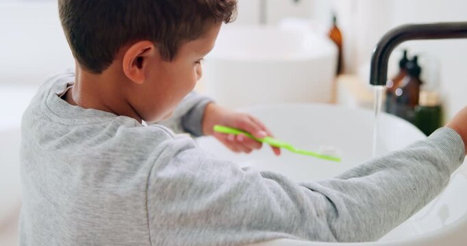 Bathroom, oral hygiene and child with toothbrush in morning, water or cleaning teeth with toothpaste. Home, sink and kid with dental health tool for wellness, grooming and self care for fresh breath
