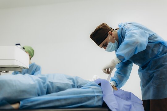 Ophthalmologist preparing patient for eye laser surgery