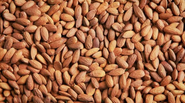Close up top down view of a large pile of raw almonds