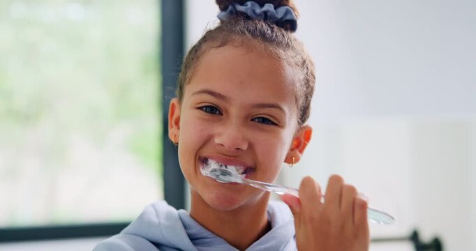 Child, face and brushing teeth with toothbrush in bathroom for dental hygiene or cleaning in home. Portrait, girl or kid in POV with morning routine for oral soap, mouth or gum healthcare in house