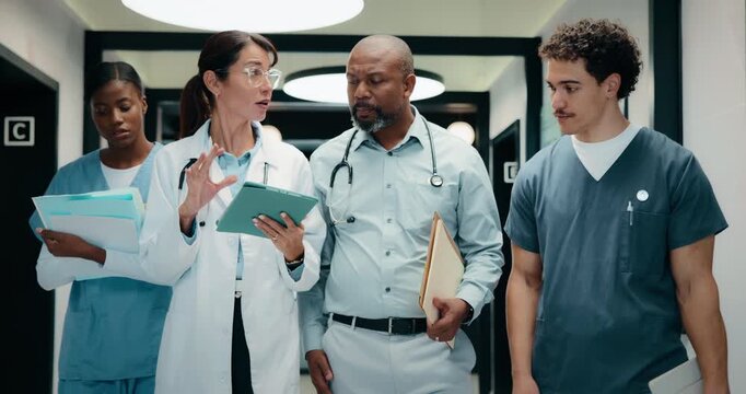 Tablet, walking and medical team at clinic for discussion, planning schedule or insurance documents. Hospital, people or doctors with tech for healthcare report, advice or help with nurses in hallway