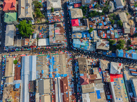 Aerial view of a dense urban market area with colorful rooftops and crowded streets in Monrovia, Montserrado, Liberia.