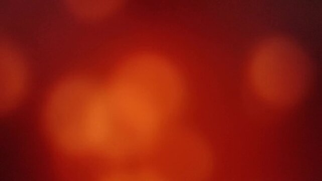 Abstract red orange glowing light background with soft bokeh and warm cinematic motion blur.
