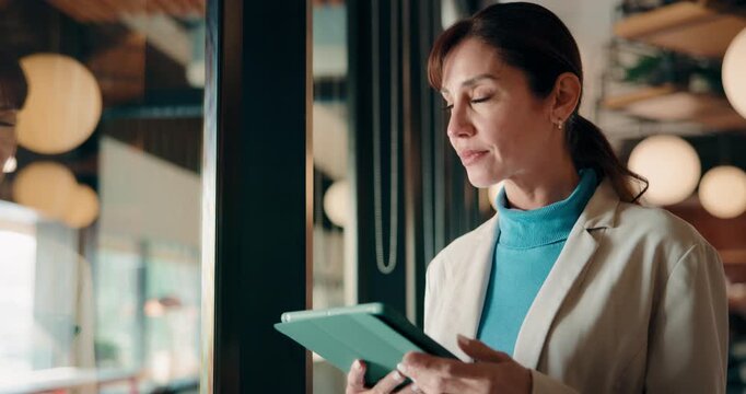 Cafe, window and businesswoman with tablet, idea and brand manager with creative choice and planning. Remote work, decision and mature person with tech for project, happy or digital marketing in shop