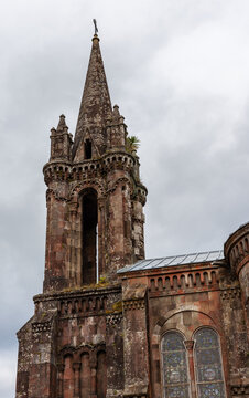 Ermida de Nossa Senhora das Vitorias. Stone chapel tower on Sao Miguel Island in the Azores. Weathered stone and stained glass visible. Portugal.