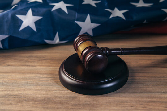 judge gavel and american flag on wooden table, law and justice concept