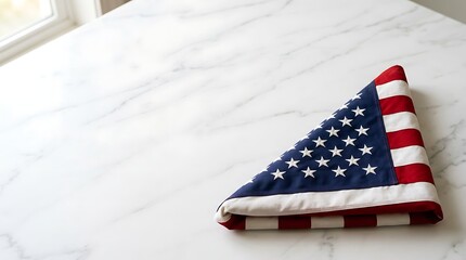 American Flag Folded on White Marble Surface with Natural Light