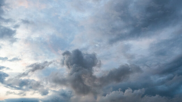 Dark rain cloud dramatic sky summer tropical thunder storm sky and fluffy black darkness cloud nearly raining cloudscape. Dark gray sky cloudy environment. Nimbus raincloud skyline climate background