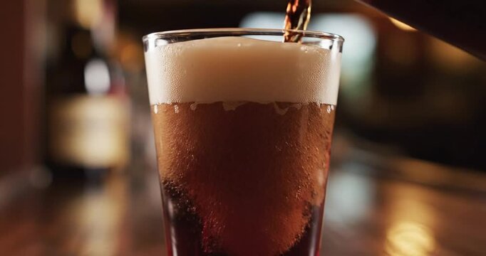 Pouring Dark Beer into a Glass.