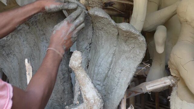 Traditional kumartuli artisans crafting sacred clay idols