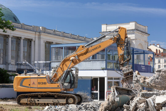 Nancy, France - June 3rd 2020 : View on a yellow crawler excavator Liebherr R 936 Litronic for the d&eacute;molition of an old building on a construction site.