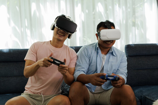 Friends immersing in virtual reality gaming, wearing vr headsets and holding game controllers, enjoying interactive metaverse entertainment together at home