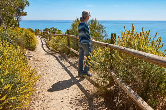 Senior woman in a cami de ronda. Mediterranean sea, Catalonia