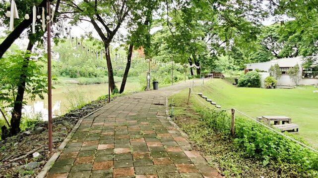 The park's pathway is bordered by the river on the left and a grassy area lower than the path on the right, offering a view that allows you to fully immerse yourself in nature.