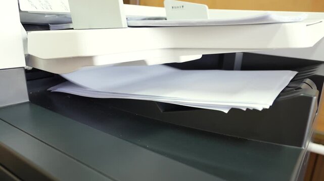 Pile of A4 paperwork documents are print out from photocopy machine in fast motion. 4K footage.
