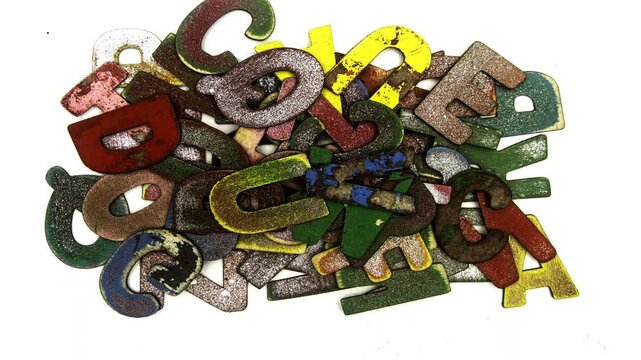 old painted wooden letter piling up isolated on white 