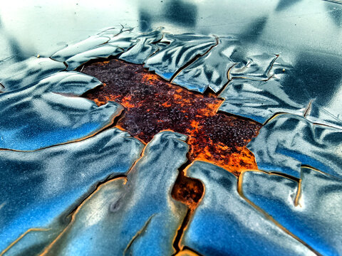 High contrast black and white image showcasing surface deterioration and radial cracks in pavement