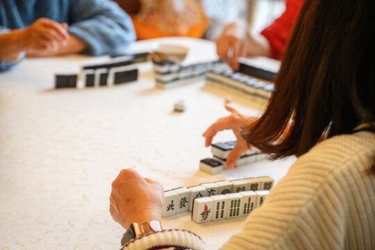Family playing a game of Mahjong