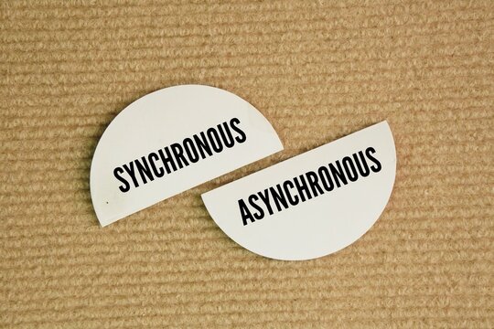 Paper with the words synchronous and asynchronous. live instruction component occurring at a set time.