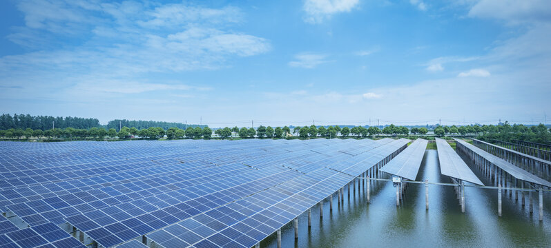 Rural Floating Photovoltaic Power Plant on Water with Blue Sky and Tree Line