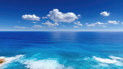Fototapeta premium Vast Tranquil Ocean Scene Beneath Clear Blue Sky with Small Fluffy Clouds Reflecting on Calm Water Surface in Bright Daylight