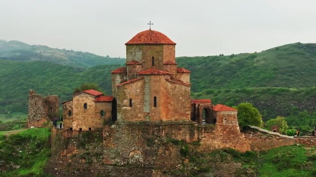 High altitude drone footage of the famous Jvari Monastery in Georgia with expansive landscapes and historic religious architecture.