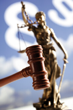 Gavel with statue of justice, close-up