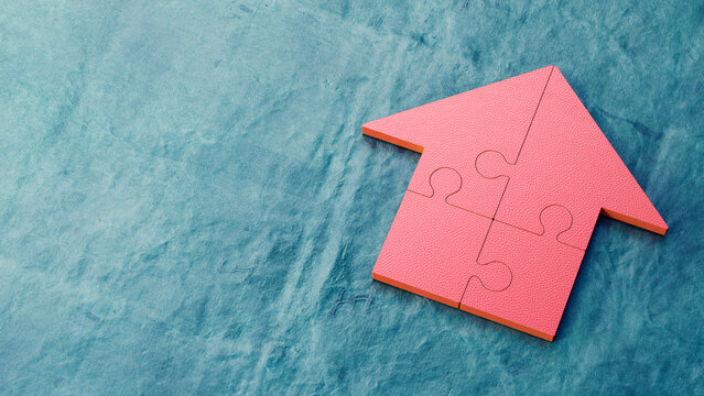 Red jigsaw house on blue background