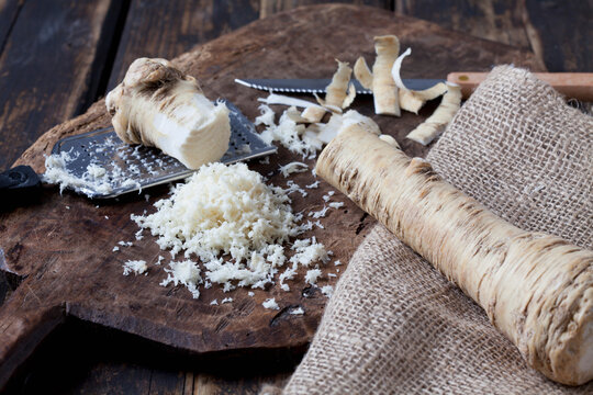 Grated horseradish on wooden board