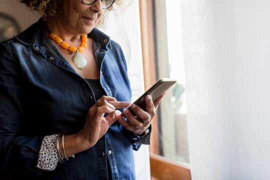 Woman using phablet by the window