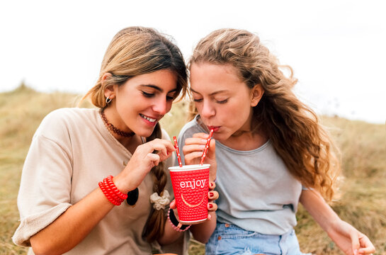 Two best friends sharing a drink
