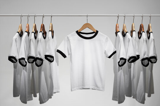 Football shirts on clothes hangers, studio shot