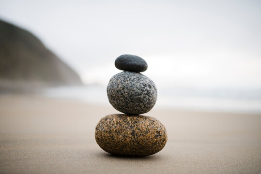 Spain, three rocks balanced on the beach