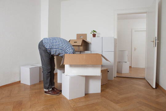 Man searching head first in cardboard box